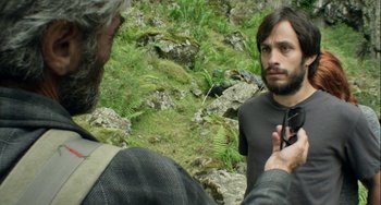Movie still from “The Loneliest Planet” (2011), directed by Julia Loktev – A man standing next to another man on a rocky hillside; Close Up shot, Over the shoulder angle