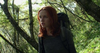 Movie still from “The Loneliest Planet” (2011), directed by Julia Loktev – A woman with a backpack walking through the woods; Close Up shot, Low angle