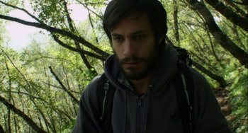 Movie still from “The Loneliest Planet” (2011), directed by Julia Loktev – A man with a beard wearing a jacket and a backpack; Close Up shot, High angle