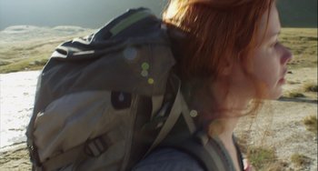 Movie still from “The Loneliest Planet” (2011), directed by Julia Loktev – A person with a backpack sitting on the ground; Extreme Close Up shot, Low angle