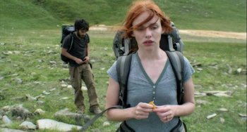 Movie still from “The Loneliest Planet” (2011), directed by Julia Loktev – A woman in a gray shirt and a man in a black shirt are on a trail; Medium shot, Low angle