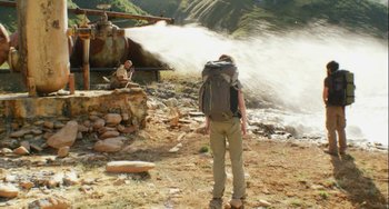 Movie still from “The Loneliest Planet” (2011), directed by Julia Loktev – A man with a backpack standing in front of a helicopter; Wide shot, Low angle