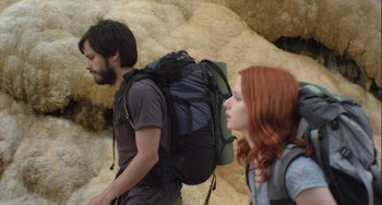 Movie still from “The Loneliest Planet” (2011), directed by Julia Loktev – A man and a woman with backpacks walking on a trail; Medium shot, Low angle