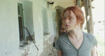 Movie still from “The Loneliest Planet” (2011), directed by Julia Loktev – A woman standing in an unfinished room looking into the distance; Close Up shot, Low angle