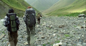 Movie still from “The Loneliest Planet” (2011), directed by Julia Loktev – A couple of people with backpacks walking on a rocky path; Wide shot, High angle