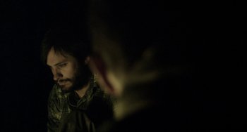 Movie still from “The Loneliest Planet” (2011), directed by Julia Loktev – A man with a beard is looking into a mirror; Close Up shot, Over the shoulder angle