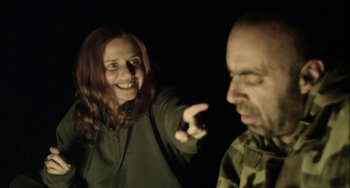 Movie still from “The Loneliest Planet” (2011), directed by Julia Loktev – A man and a woman are pointing at each other in the dark; Medium shot, Over the shoulder angle