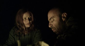 Movie still from “The Loneliest Planet” (2011), directed by Julia Loktev – A woman and a man are looking at each other in the dark; Close Up shot, Over the shoulder angle