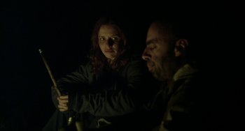 Movie still from “The Loneliest Planet” (2011), directed by Julia Loktev – A woman and a man in a dark room; Medium shot, Over the shoulder angle