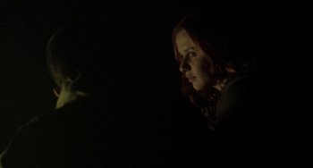 Movie still from “The Loneliest Planet” (2011), directed by Julia Loktev – A woman is standing in the dark looking at something; Close Up shot, Low angle
