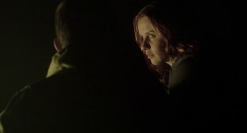 Movie still from “The Loneliest Planet” (2011), directed by Julia Loktev – A woman with red hair is looking at the camera; Close Up shot, Over the shoulder angle