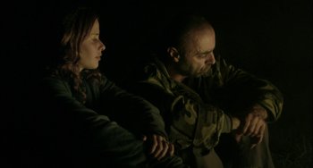 Movie still from “The Loneliest Planet” (2011), directed by Julia Loktev – A man and a woman sitting next to each other in the dark; Medium shot, Low angle