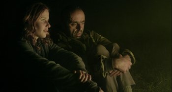 Movie still from “The Loneliest Planet” (2011), directed by Julia Loktev – A man and a woman sitting next to each other in the dark; Medium shot, Low angle