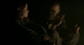 Movie still from “The Loneliest Planet” (2011), directed by Julia Loktev – A man and a woman sitting in a dark room talking; Medium shot, Over the shoulder angle