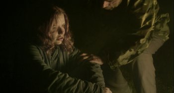 Movie still from “The Loneliest Planet” (2011), directed by Julia Loktev – A man and a woman sitting in a dark room; Medium shot, Over the shoulder angle