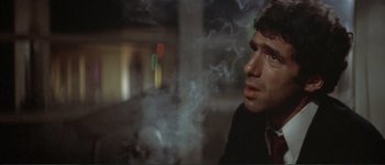 Movie still from “The Long Goodbye” (1973), directed by Robert Altman – A person with smoke coming out of their mouth; Close Up shot, Low angle