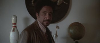 Movie still from “The Long Goodbye” (1973), directed by Robert Altman – A person wearing a suit and tie; Close Up shot, Low angle