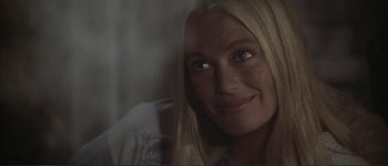 Movie still from “The Long Goodbye” (1973), directed by Robert Altman – A woman with long blonde hair smiling for the camera; Close Up shot, Over the shoulder angle