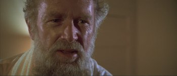 Movie still from “The Long Goodbye” (1973), directed by Robert Altman – An old man with a beard is looking at the camera; Close Up shot, Over the shoulder angle