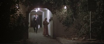 Movie still from “The Long Goodbye” (1973), directed by Robert Altman – A man and a woman are walking down a hallway; Wide shot, Low angle