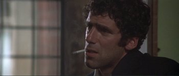 Movie still from “The Long Goodbye” (1973), directed by Robert Altman – A person smoking a cigarette; Close Up shot, Low angle
