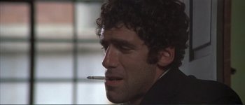 Movie still from “The Long Goodbye” (1973), directed by Robert Altman – A person smoking a cigarette; Close Up shot, Low angle