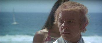 Movie still from “The Long Goodbye” (1973), directed by Robert Altman – An older woman looks at the camera while a young woman looks on; Close Up shot, Low angle