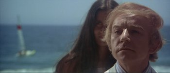 Movie still from “The Long Goodbye” (1973), directed by Robert Altman – A man and a woman standing next to each other near the ocean; Close Up shot, Low angle