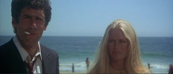 Movie still from “The Long Goodbye” (1973), directed by Robert Altman – A woman standing next to a man on the beach; Close Up shot, Low angle
