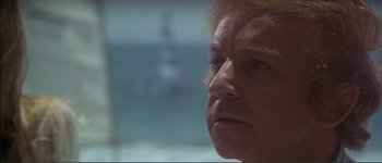 Movie still from “The Long Goodbye” (1973), directed by Robert Altman – An older woman looking out of a window at the ocean; Close Up shot, Low angle