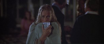 Movie still from “The Long Goodbye” (1973), directed by Robert Altman – A woman holding a cell phone up to her face; Medium shot, Over the shoulder angle