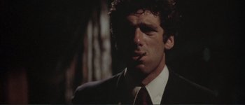 Movie still from “The Long Goodbye” (1973), directed by Robert Altman – A person wearing a suit and tie; Close Up shot, Low angle