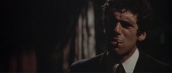 Movie still from “The Long Goodbye” (1973), directed by Robert Altman – A person wearing a suit and tie; Close Up shot, Low angle