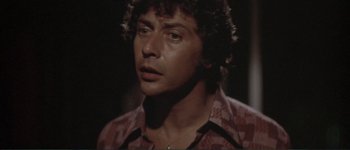 Movie still from “The Long Goodbye” (1973), directed by Robert Altman – A person wearing a red shirt; Close Up shot, Low angle