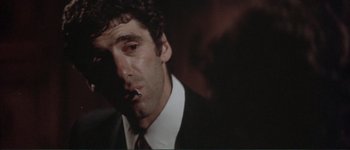 Movie still from “The Long Goodbye” (1973), directed by Robert Altman – A person wearing a suit and tie; Close Up shot, Low angle