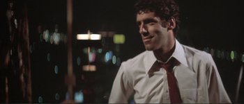 Movie still from “The Long Goodbye” (1973), directed by Robert Altman – A man wearing a white shirt and a red neck tie; Close Up shot, Low angle