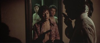 Movie still from “The Long Goodbye” (1973), directed by Robert Altman – A group of people standing in front of a bathroom mirror; Medium shot, Low angle
