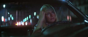 Movie still from “The Long Goodbye” (1973), directed by Robert Altman – A woman sitting in the back seat of a car at night; Close Up shot, Over the shoulder angle