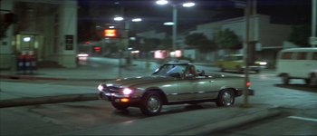 Movie still from “The Long Goodbye” (1973), directed by Robert Altman – A car driving down a street at night; Wide shot, High angle