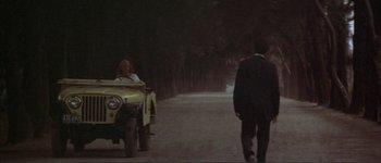 Movie still from “The Long Goodbye” (1973), directed by Robert Altman – A man and a woman walking down a road; Wide shot, Over the shoulder angle