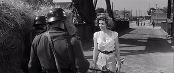 Movie still from “The Longest Day” (1962), directed by Ken Annakin – A black and white photo of a woman and a roman soldier; Medium shot, Over the shoulder angle