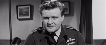 Movie still from “The Longest Day” (1962), directed by Ken Annakin – An old photo of a man wearing a uniform; Close Up shot, Low angle