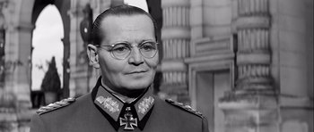 Movie still from “The Longest Day” (1962), directed by Ken Annakin – An older man wearing glasses and wearing a uniform; Close Up shot, Low angle