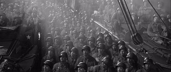 Movie still from “The Longest Day” (1962), directed by Ken Annakin – A large group of men in military uniforms; Wide shot, High angle