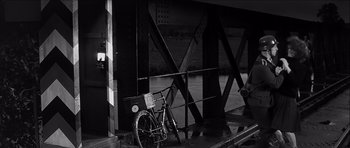 Movie still from “The Longest Day” (1962), directed by Ken Annakin – A bicycle parked on the side of a bridge; Wide shot, High angle