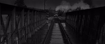 Movie still from “The Longest Day” (1962), directed by Ken Annakin – A black and white photo of a train on the tracks at night; Extreme Wide shot, High angle