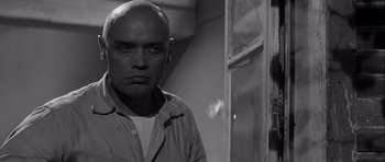 Movie still from “The Longest Day” (1962), directed by Ken Annakin – Black and white photograph of a man with bald head; Close Up shot, Low angle