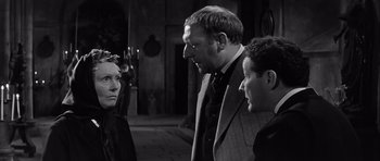 Movie still from “The Longest Day” (1962), directed by Ken Annakin – Two men and a woman are talking to each other; Medium shot, Over the shoulder angle