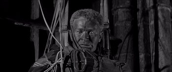 Movie still from “The Longest Day” (1962), directed by Ken Annakin – An old man with a beard is wearing a harness; Close Up shot, Low angle