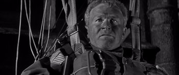 Movie still from “The Longest Day” (1962), directed by Ken Annakin – A person with a rifle; Close Up shot, Low angle